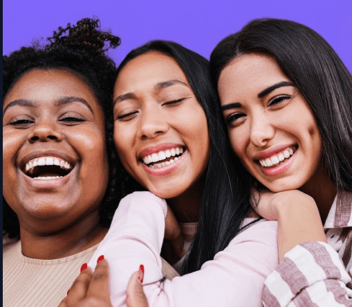Three women smiling together